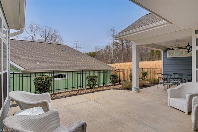 view of patio featuring a ceiling fan, outdoor dining space, and fence