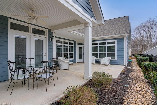 view of patio with a ceiling fan, outdoor dining area, fence, and french doors