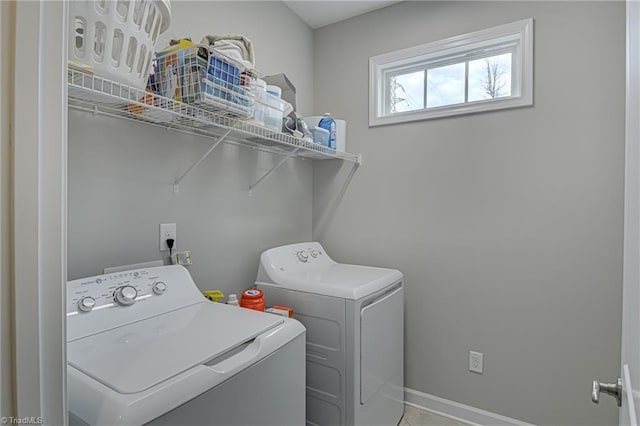 laundry room with laundry area, baseboards, and washer and dryer