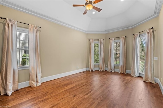 spare room with ceiling fan, baseboards, wood finished floors, and crown molding