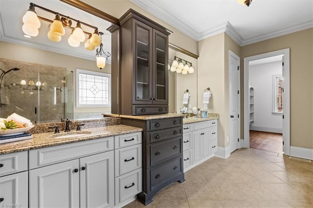 full bath with a stall shower, vanity, and ornamental molding