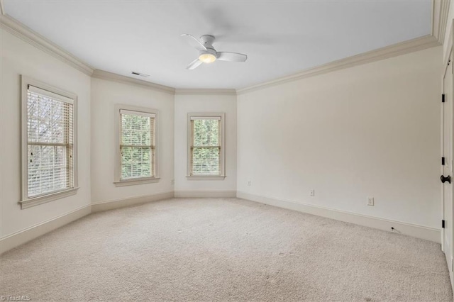 empty room with visible vents, light carpet, and ornamental molding