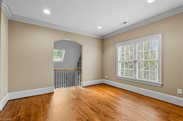 spare room featuring wood finished floors, baseboards, and visible vents