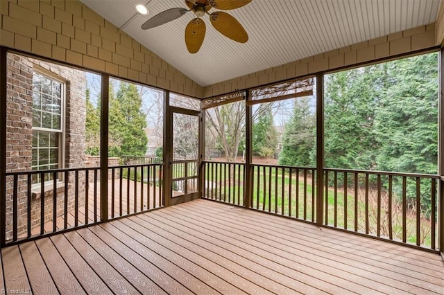 unfurnished sunroom featuring a ceiling fan and lofted ceiling