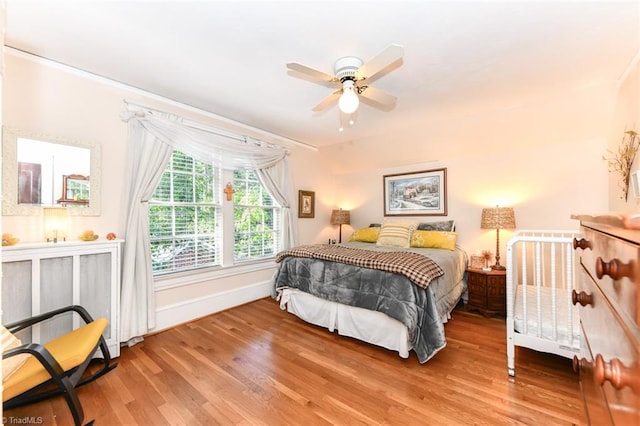 bedroom with hardwood / wood-style flooring and ceiling fan