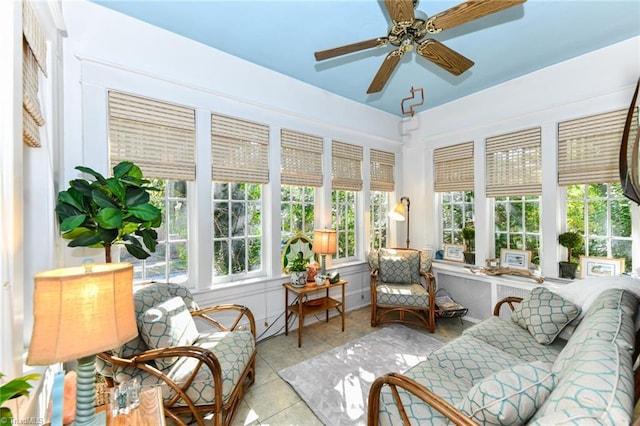 sunroom / solarium featuring ceiling fan