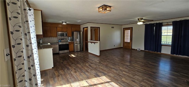 kitchen featuring sink, backsplash, dark hardwood / wood-style flooring, ceiling fan, and stainless steel appliances