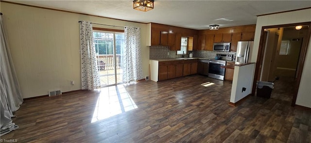 kitchen featuring stainless steel appliances, ornamental molding, backsplash, and dark hardwood / wood-style flooring