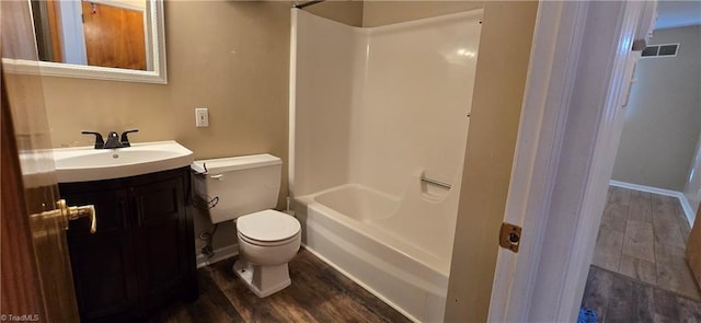 full bathroom featuring vanity, hardwood / wood-style floors, shower / tub combination, and toilet