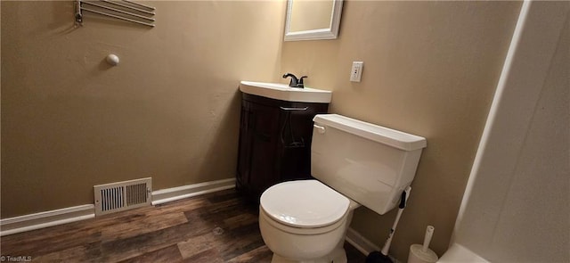 bathroom featuring vanity, toilet, and hardwood / wood-style floors