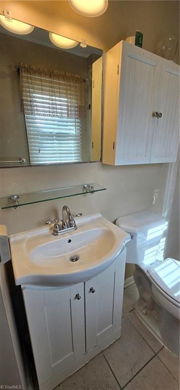 bathroom with vanity, tile patterned floors, and toilet