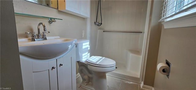 bathroom with walk in shower, vanity, and toilet