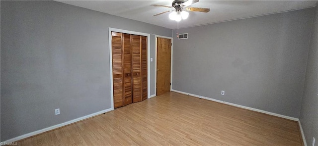 unfurnished bedroom featuring light hardwood / wood-style flooring, a closet, and ceiling fan