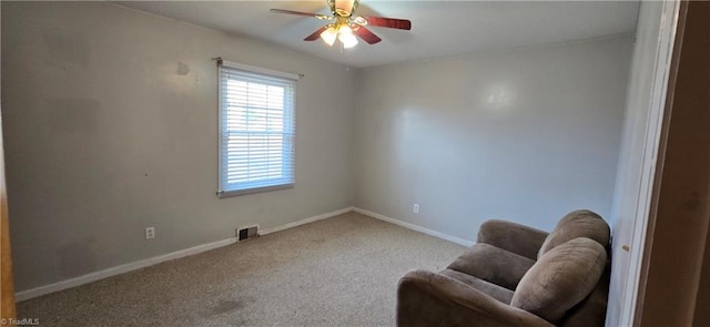 living area featuring ceiling fan and carpet floors