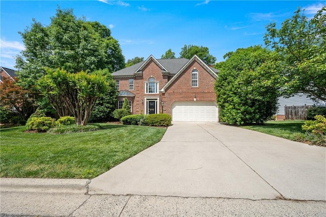 colonial home with an attached garage, driveway, and brick siding