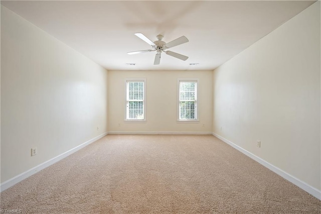 unfurnished room featuring baseboards, ceiling fan, and light carpet