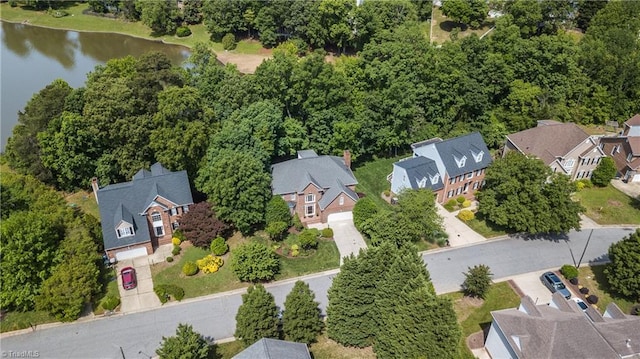 aerial view of residential area with a large body of water