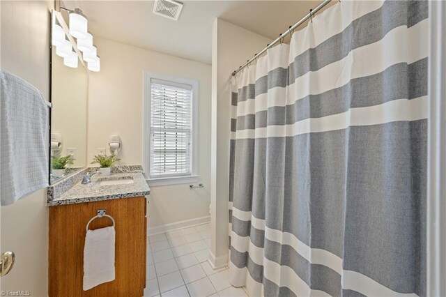 bathroom with tile patterned floors, vanity, and a shower with shower curtain