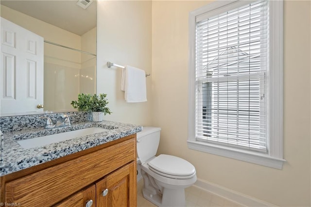 full bathroom featuring toilet, baseboards, vanity, and a shower
