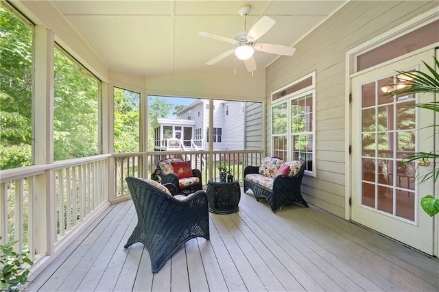 sunroom / solarium featuring ceiling fan and vaulted ceiling