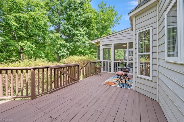 wooden deck with a sunroom