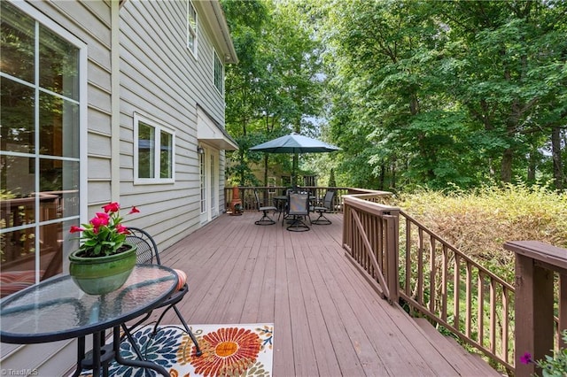 wooden terrace featuring outdoor dining area
