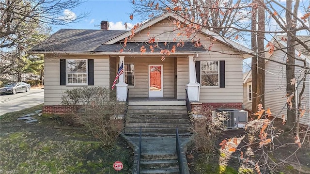 bungalow-style house with central AC unit