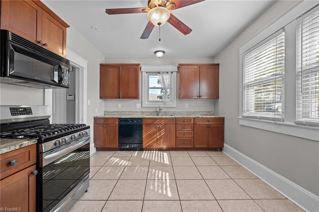 kitchen featuring black appliances, sink, light tile patterned floors, ceiling fan, and light stone counters