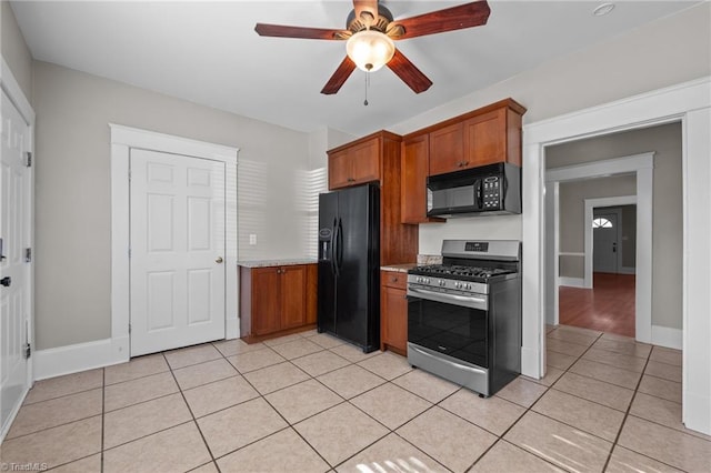 kitchen featuring ceiling fan, light tile patterned floors, and black appliances