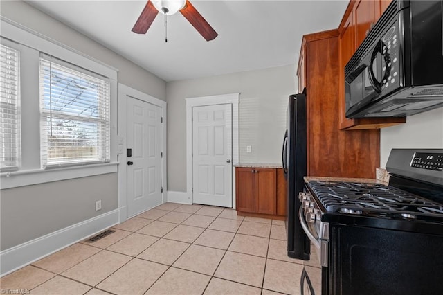 kitchen with ceiling fan, light tile patterned floors, and black appliances