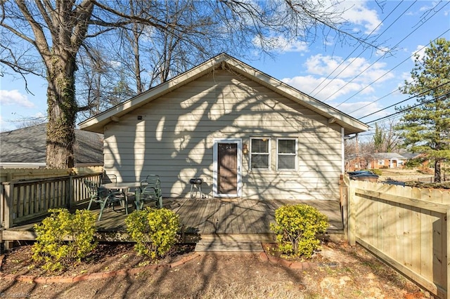 rear view of property featuring a wooden deck