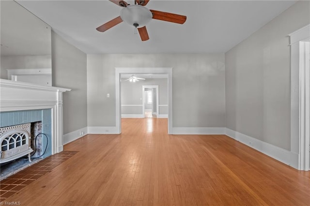 unfurnished living room with ceiling fan and light wood-type flooring