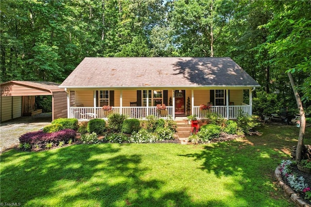 1044 Riverwood Rd, Lexington, NC 27292 - view of front facade featuring covered porch, a detached carport, dirt driveway, and a front lawn