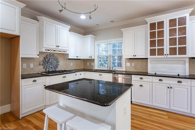 kitchen featuring stainless steel appliances, light hardwood / wood-style floors, a kitchen island, and white cabinets