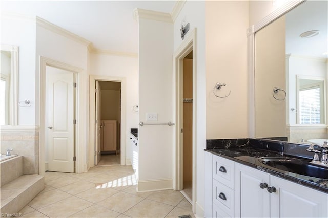 bathroom featuring crown molding, a relaxing tiled tub, tile patterned floors, and vanity