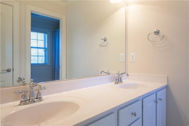 bathroom with ornamental molding and vanity