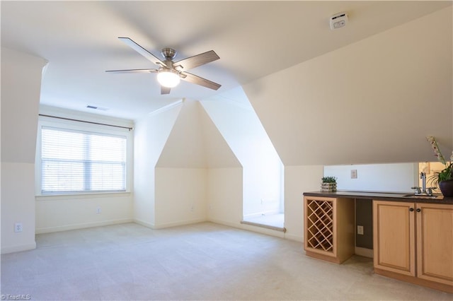 bonus room featuring ceiling fan, light colored carpet, vaulted ceiling, and sink