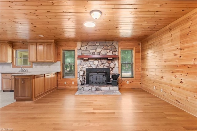 7849 Circle L Trl, Rougemont, NC 27572 - unfurnished living room with wooden ceiling, light wood-style flooring, wooden walls, and a fireplace