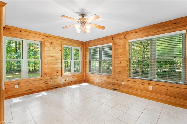7849 Circle L Trl, Rougemont, NC 27572 - unfurnished room with wooden walls, a ceiling fan, and light tile patterned flooring