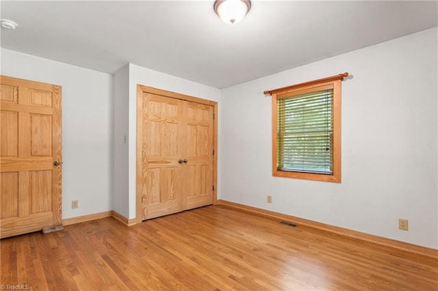 7849 Circle L Trl, Rougemont, NC 27572 - unfurnished bedroom with light wood finished floors and a closet