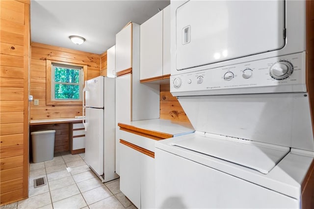 7849 Circle L Trl, Rougemont, NC 27572 - laundry area featuring estacked washer and dryer, light tile patterned floors, and wooden walls