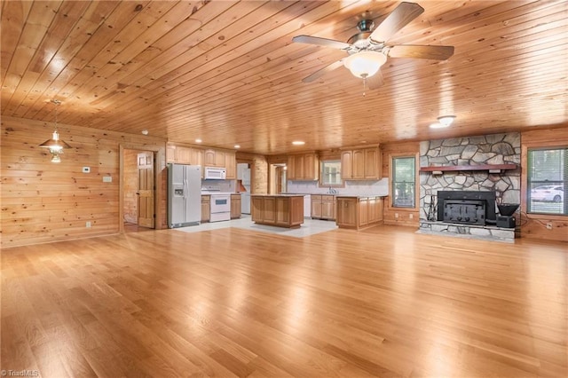7849 Circle L Trl, Rougemont, NC 27572 - unfurnished living room with wood ceiling, light wood-style flooring, ceiling fan, a fireplace, and wooden walls