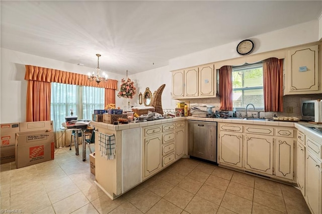 1204 Hobbs Rd, Greensboro, NC 27410 - kitchen featuring dishwasher, a peninsula, a chandelier, and backsplash
