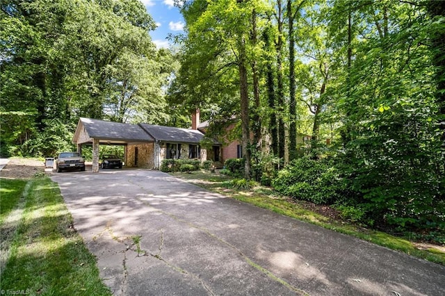 1204 Hobbs Rd, Greensboro, NC 27410 - view of front of house with driveway, a chimney, and an attached carport