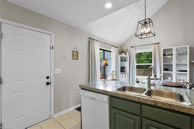 kitchen featuring hanging light fixtures, a sink, green cabinets, lofted ceiling, and white dishwasher
