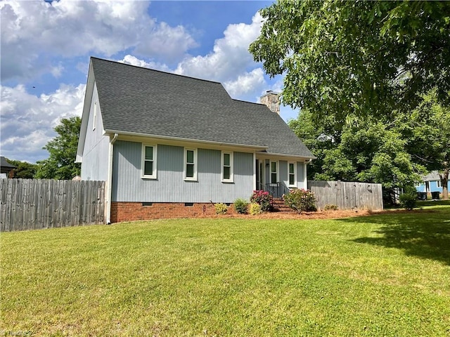 cape cod home with a shingled roof, a front lawn, fence, and crawl space