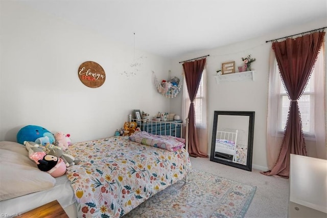 bedroom with carpet and multiple windows