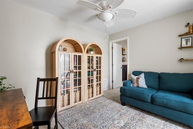 carpeted living area with a ceiling fan and visible vents
