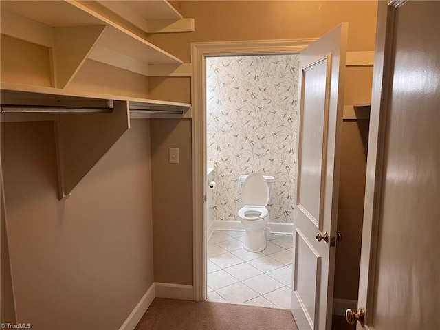 spacious closet featuring light tile patterned floors