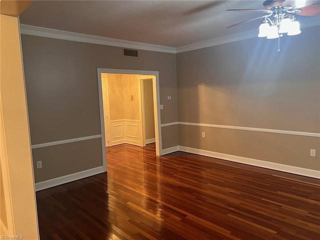 empty room with ornamental molding, ceiling fan, and dark hardwood / wood-style floors